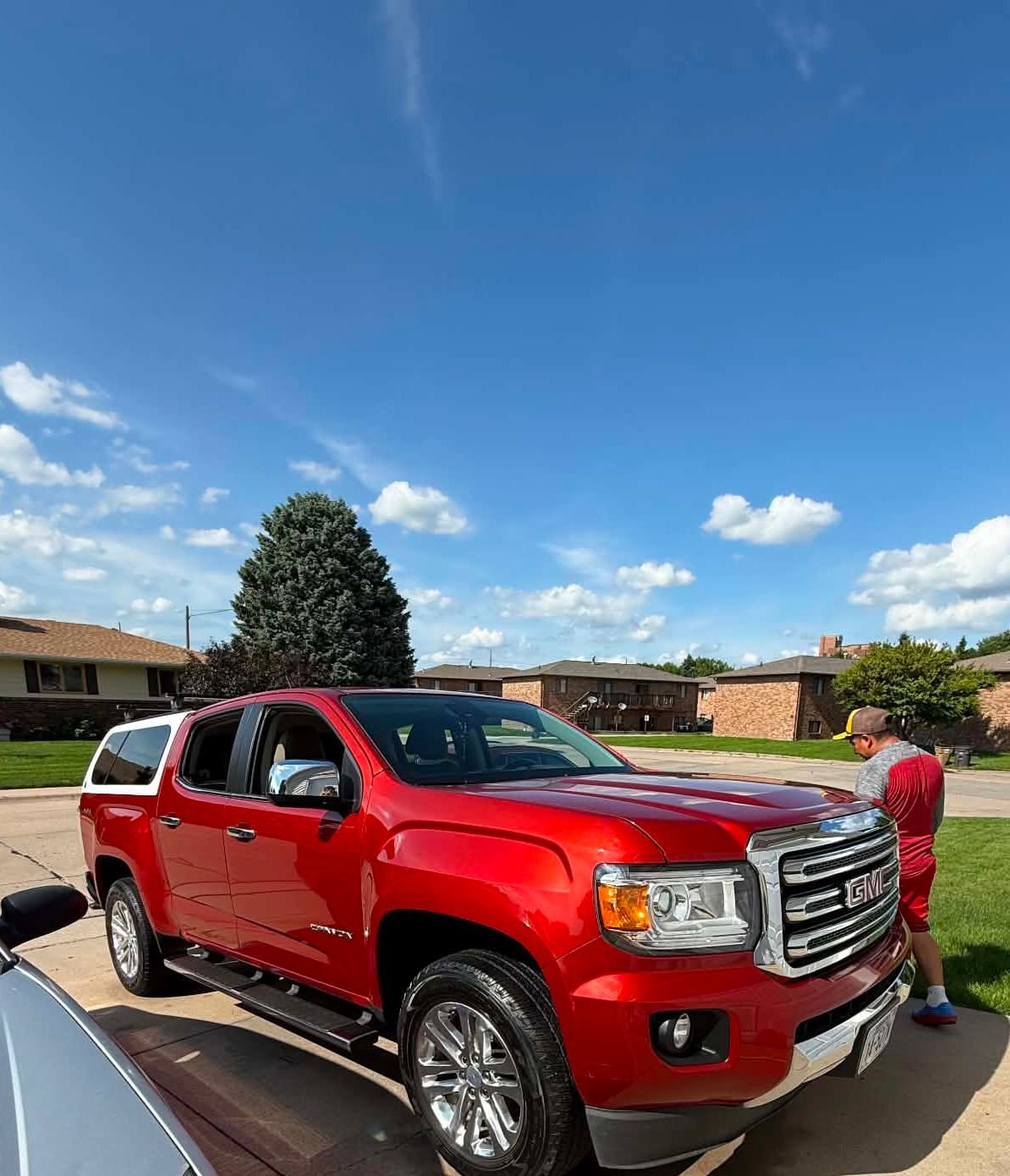 PC Car Detailing working on a red GMC truck